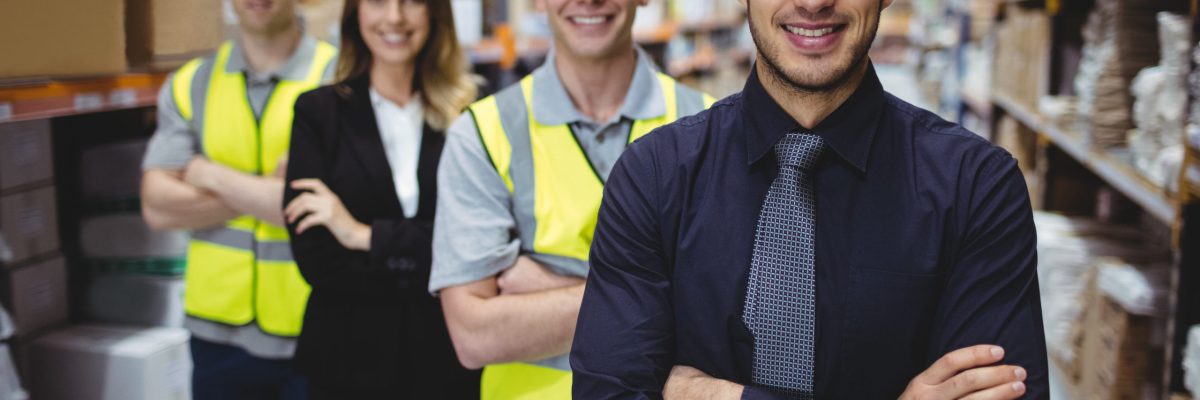 Portrait of warehouse manager and workers in warehouse